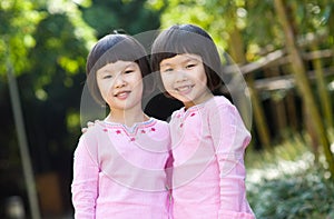 Smiling asian twin girls