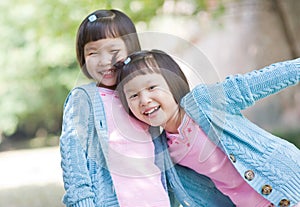 Smiling asian twin girls