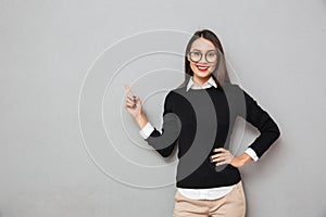 Smiling asian woman in business clothes and eyeglasses