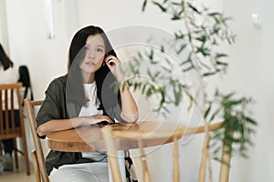 A smiling Asian woman in a cafe