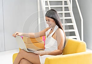 Smiling asian woman open laptop computer surprised online shopping