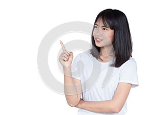 Smiling asian woman pointing up and looking at the camera isolated on white background