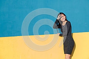 Smiling asian woman posing on colorful background