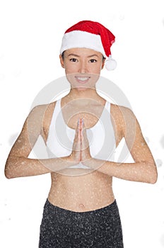 Smiling asian woman in Santa`s hat engaged in fitness