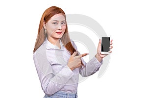 Smiling Asian woman standing in casual shirt holding mobile phone and  pointing on smartphone isolated on white background