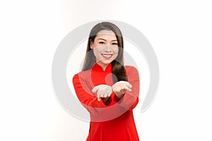 Smiling Asian woman studio portrait isolated on white background showing something on the palms of her open two hands holding for