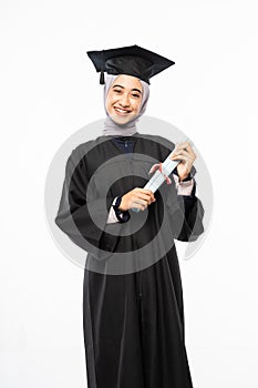 Smiling asian woman wearing black toga standing holding certificate roll