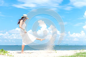 Smiling asian woman white wearing fashion summer walking on the sandy ocean beach. Woman enjoy and relax vacation.