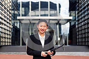smiling asiatic business woman looking at camera