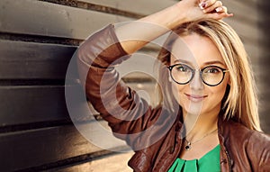 Smiling Attractive Blonde Girl With Natural Face Makeup Wearing Stylish Fashion Optical Eye Glasses. Minimalist urban clothing