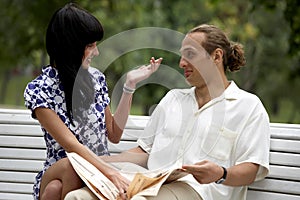 Smiling attractive couple meeting in summer park