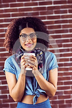 Smiling attractive hipster with take-away cup