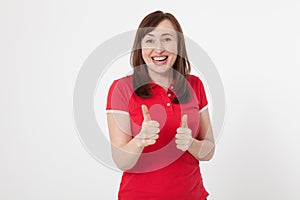 Smiling attractive middle aged woman showing thumbs up, okay on white background. Copy space.