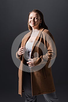 Smiling, attractive overweight girl in coat
