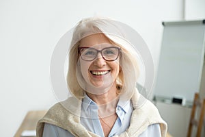 Smiling attractive senior businesswoman wearing glasses head sho