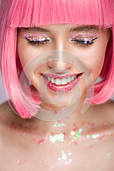 smiling attractive woman with pink hair and glitter