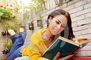 Smiling attractive woman reading book