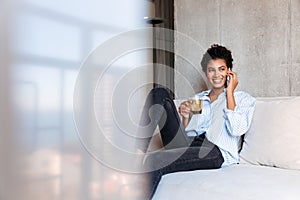 Smiling attractive young african woman wearing shirt relaxing