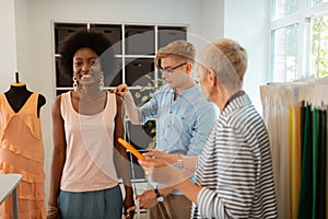 Smiling attractive young girl standing in a workshop