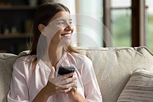 Smiling attractive young woman toasting with glass of sparkling wine.