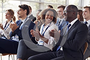 Smiling audience applauding at a business seminar photo