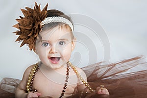 Smiling baby ballerina in brown tutu