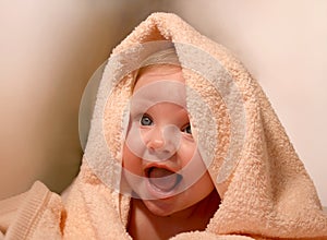 Smiling baby in bath towel