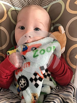 Smiling baby boy with blanket