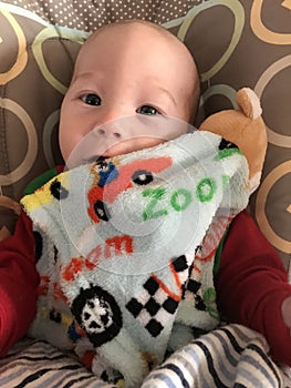 Smiling baby boy with blanket