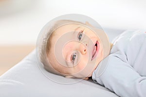 Smiling baby boy on the changing table