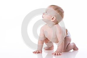 Smiling baby-boy in a diaper sitting on the floor