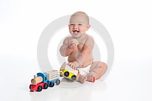 Smiling Baby Boy Playing with a Toy Train