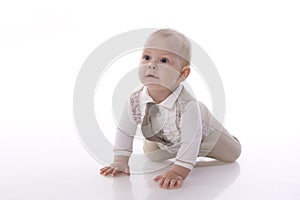 Smiling baby-boy in a romper suit crawling photo