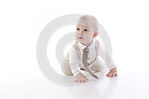 Smiling baby-boy in a romper suit crawling