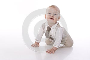 Smiling baby-boy in a romper suit crawling photo