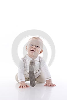 Smiling baby-boy in a romper suit crawling