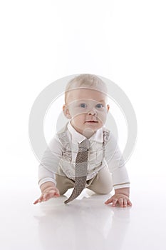 Smiling baby-boy in a romper suit crawling photo