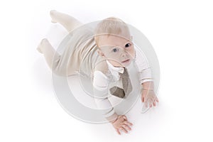 Smiling baby-boy in a romper suit crawling