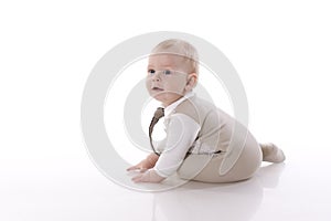Smiling baby-boy in a romper suit crawling