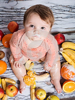 Smiling baby and fruits