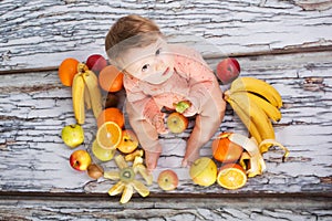 Smiling baby and fruits