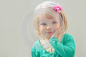 Smiling baby girl with bow
