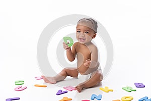 Smiling Baby Girl Playing with Letter Toys