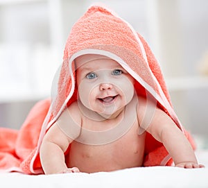 Smiling baby girl after shower or bath with towel on head