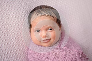 Smiling Baby Girl Swaddled in a Lavender Wrap