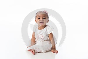 Smiling Baby Girl Wearing a White Dress