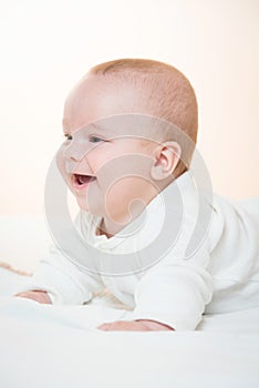 Smiling baby lying on the blanket