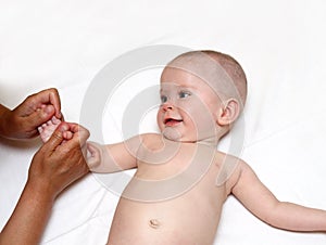 Smiling baby massaging