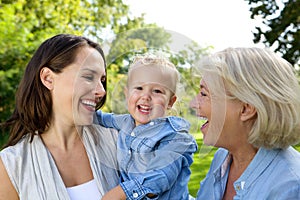 Smiling baby with mother and grandmother