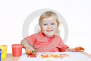 Smiling baby painting with finger